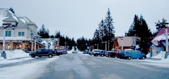 Street view of town during winter snowfall.