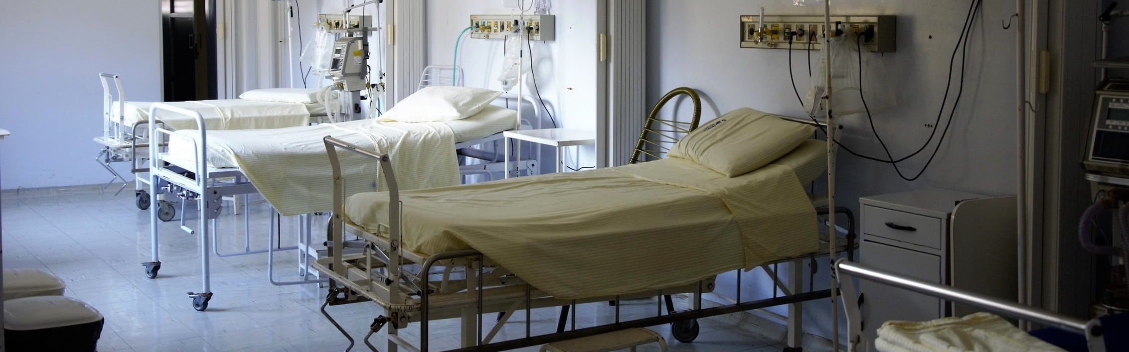 Three hospital beds in a hospital room.