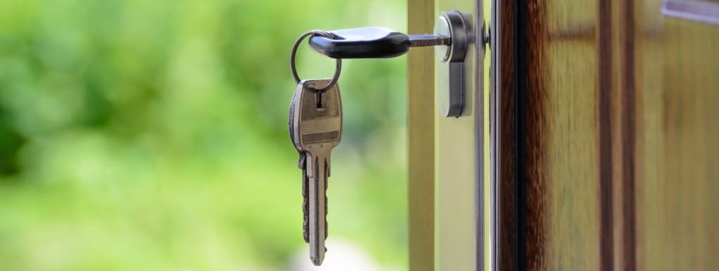 Keys in door lock opening door.