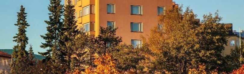 Commercial building surrounded by trees in the fall.