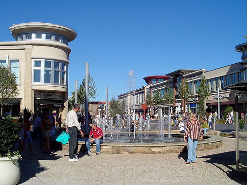 People walking and sitting by a fountain in Waukesha, Wisconsin.