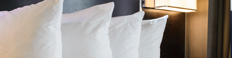 Pillows lined up on hotel bed