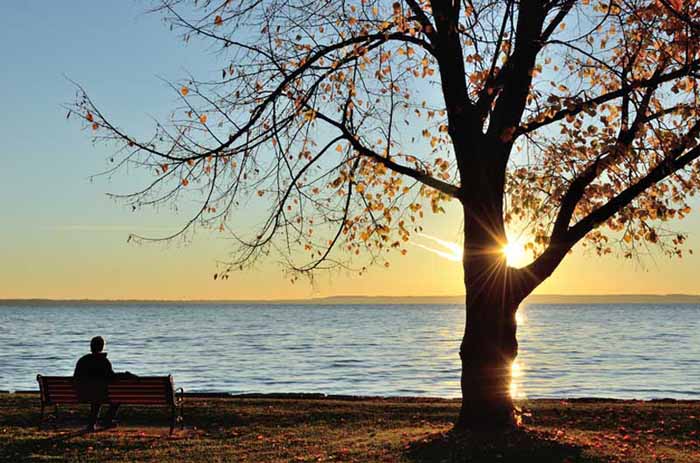 man watching the sunrise over lake winnebago